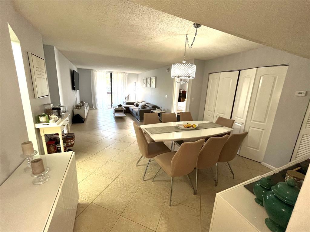 737 Southeast 1st Way, Unit 302 Deerfield Beach, FL 33441 - Photo 5 of 21 a view of a dining room with furniture and wooden floor