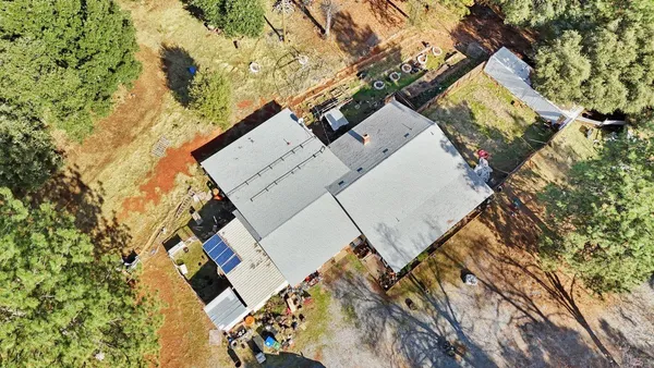 an aerial view of a house with a yard