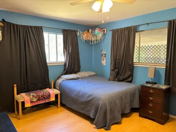 a bedroom with a bed and window