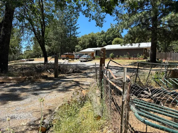 a view of a patio with table and chairs with wooden fence and floor