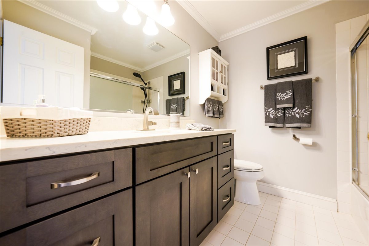 334 Clearview Circle Round Lake, IL 60073 - Photo 19 of 36 a bathroom with a sink a toilet and a mirror
