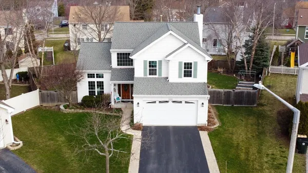 an aerial view of a house with a yard