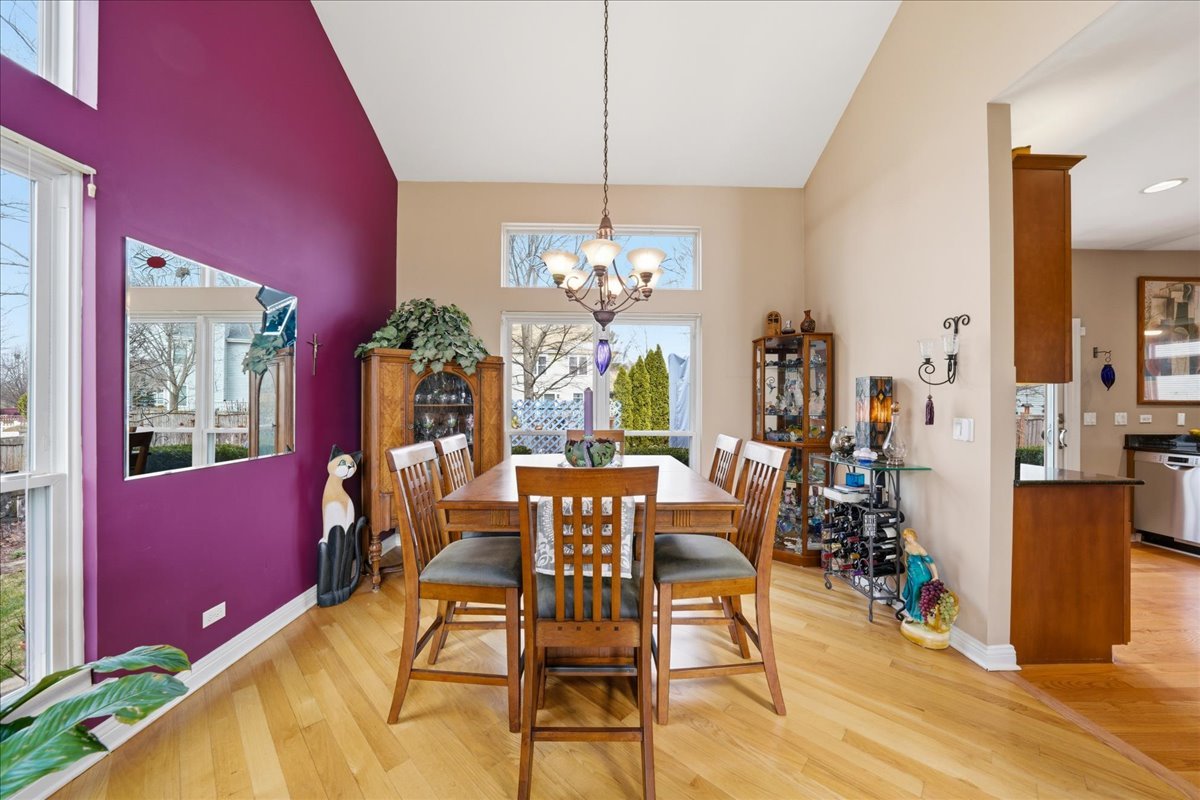 334 Clearview Circle Round Lake, IL 60073 - Photo 5 of 36 a dining room with furniture a chandelier and wooden floor