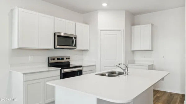 a kitchen with a sink stove and microwave
