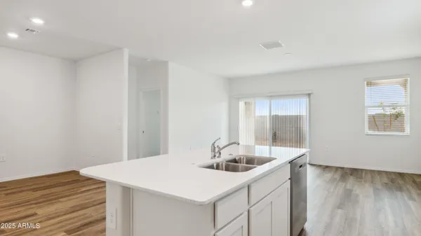 a kitchen with white cabinets a sink and dishwasher
