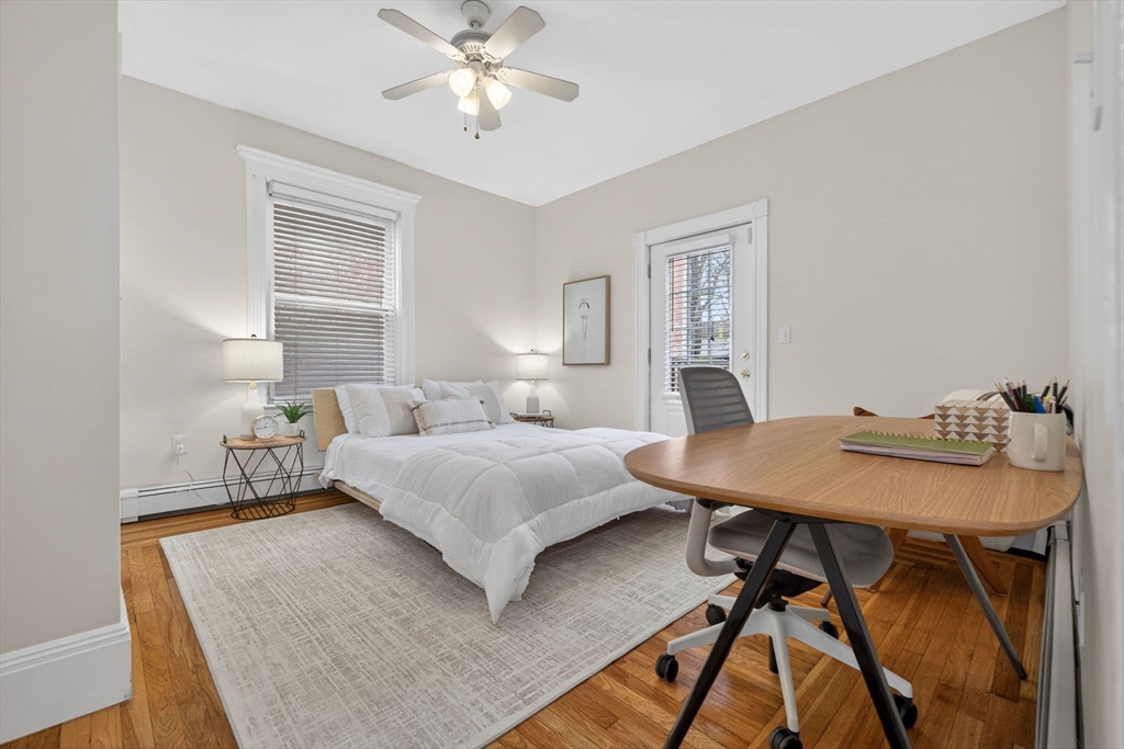 60 Iffley Road, Unit 2 Boston, MA 02130 - Photo 13 of 26 a bedroom with a bed and a table in it