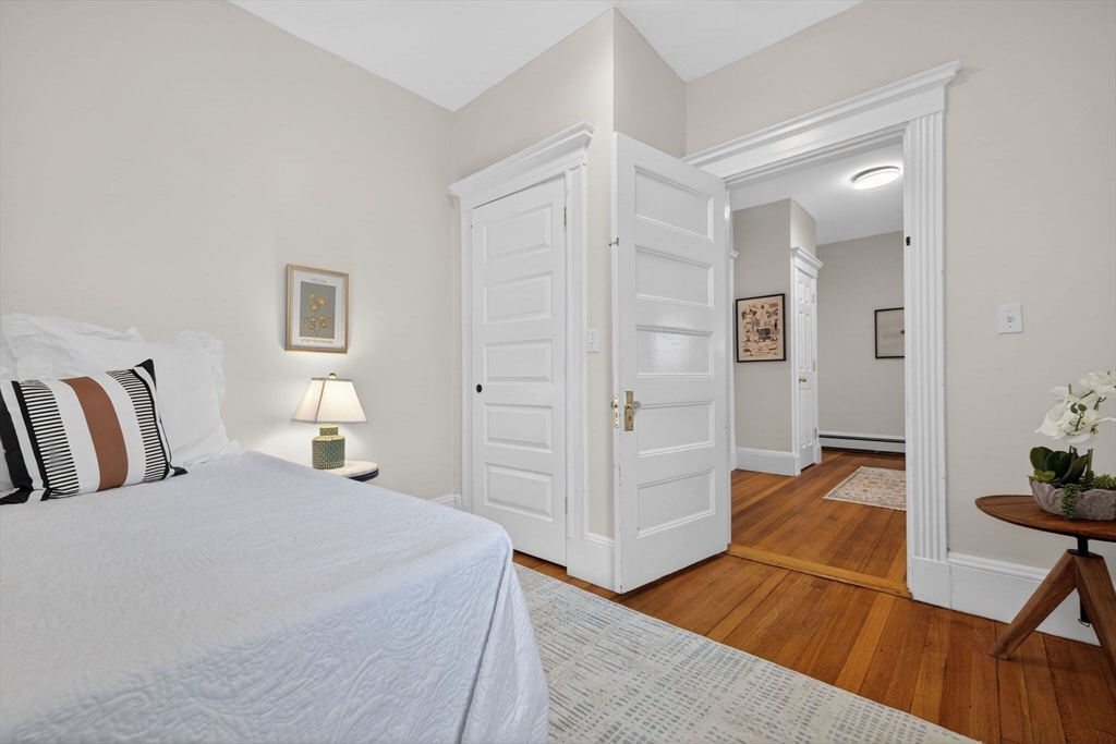 60 Iffley Road, Unit 2 Boston, MA 02130 - Photo 15 of 26 a spacious bedroom with a bed and a chair in it