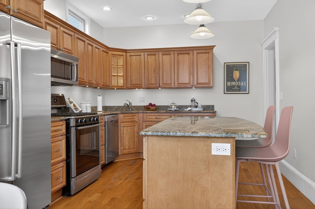 60 Iffley Road, Unit 2 Boston, MA 02130 - Photo 10 of 26 a kitchen with stainless steel appliances granite countertop a stove top oven a refrigerator a sink and a stove