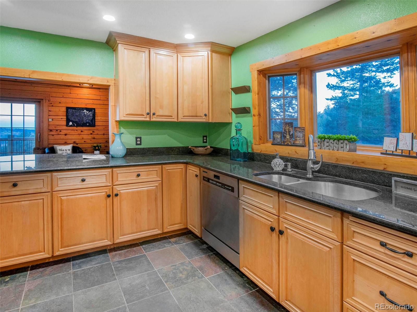 25633 Independence Trail Evergreen, CO 80439 - Photo 15 of 39 a kitchen with granite countertop sink and cabinets