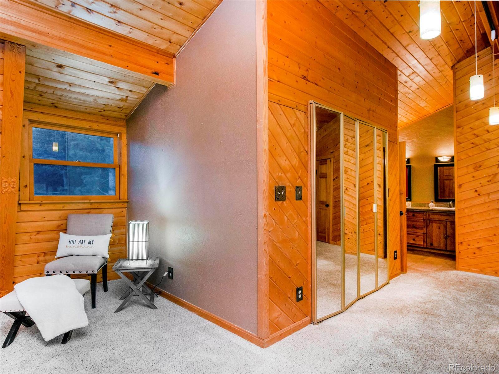 25633 Independence Trail Evergreen, CO 80439 - Photo 23 of 39 a view of a bathroom with a door and wooden door