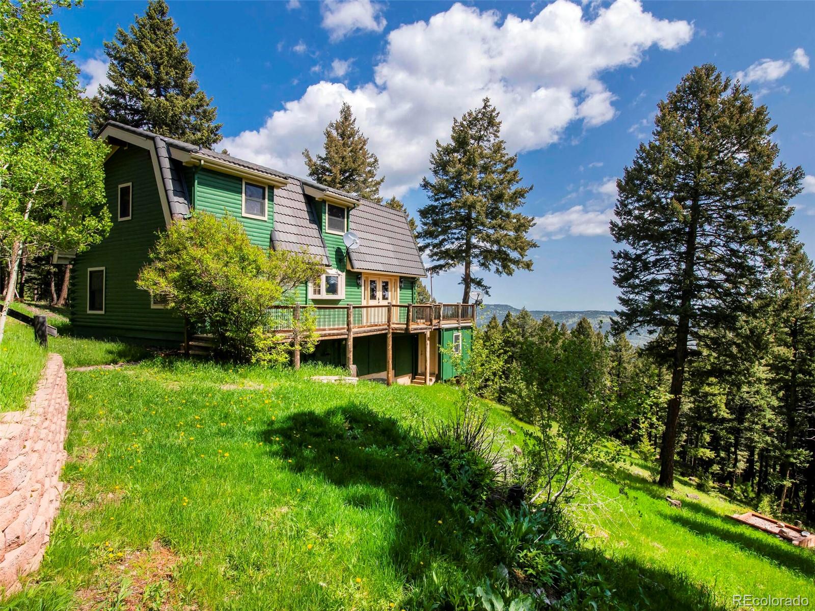 25633 Independence Trail Evergreen, CO 80439 - Photo 3 of 39 a view of a house with a yard and garden