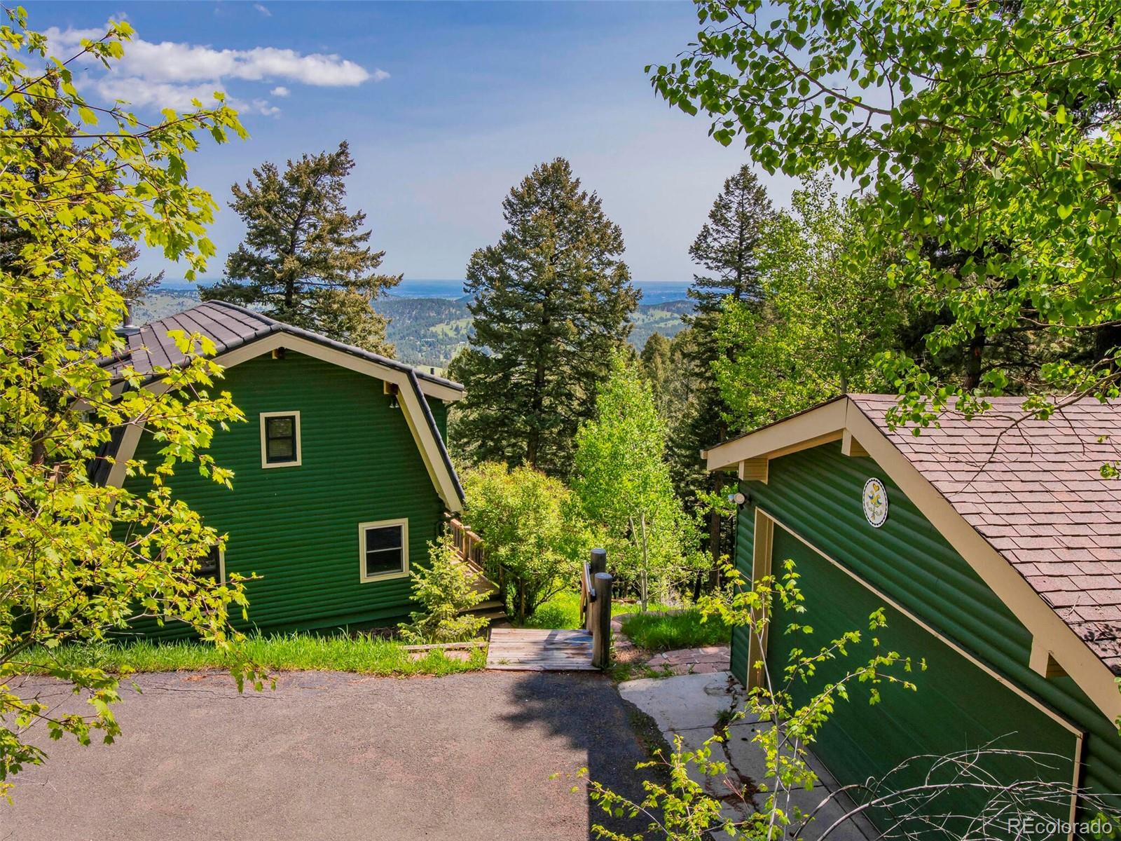 25633 Independence Trail Evergreen, CO 80439 - Photo 31 of 39 a front view of a house with garden