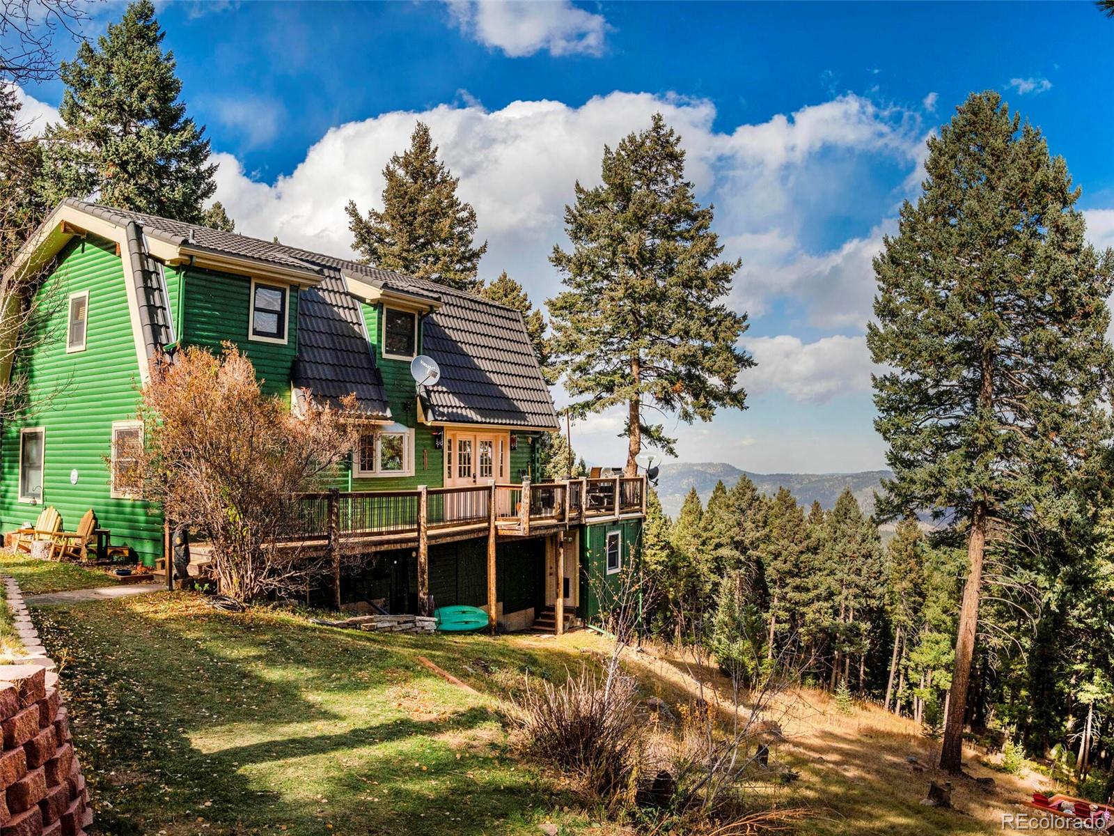 25633 Independence Trail Evergreen, CO 80439 - Photo 38 of 39 front view of a house with a yard