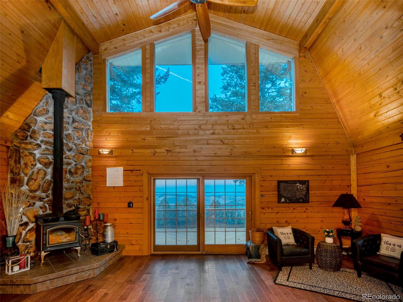 25633 Independence Trail Evergreen, CO 80439 - Photo 4 of 39 a view of a patio with table and chairs and wooden floor