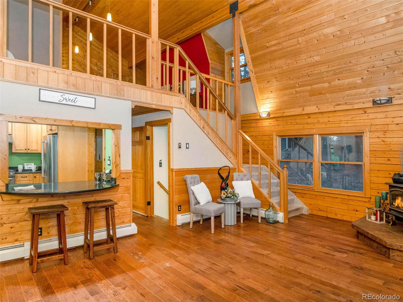 25633 Independence Trail Evergreen, CO 80439 - Photo 6 of 39 a view of a building with wooden floor and chairs