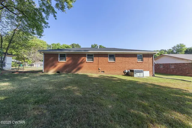 a front view of house with yard and trees
