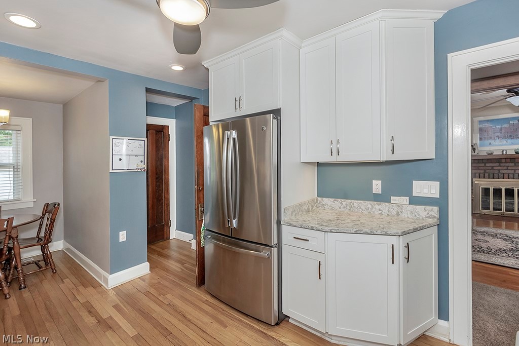 2480 Eaton Road Cleveland, OH 44118 - Photo 14 of 41 Kitchen featuring stainless steel fridge, light hardwood / wood-style flooring, white cabinetry, and ceiling fan