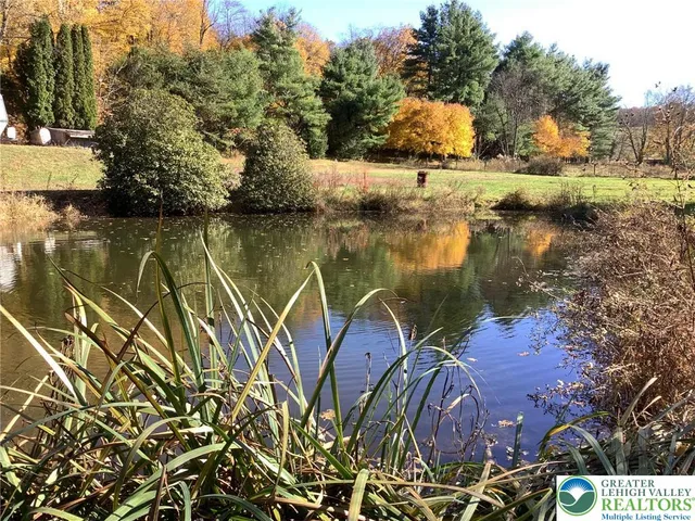 a view of a lake with a house in the background