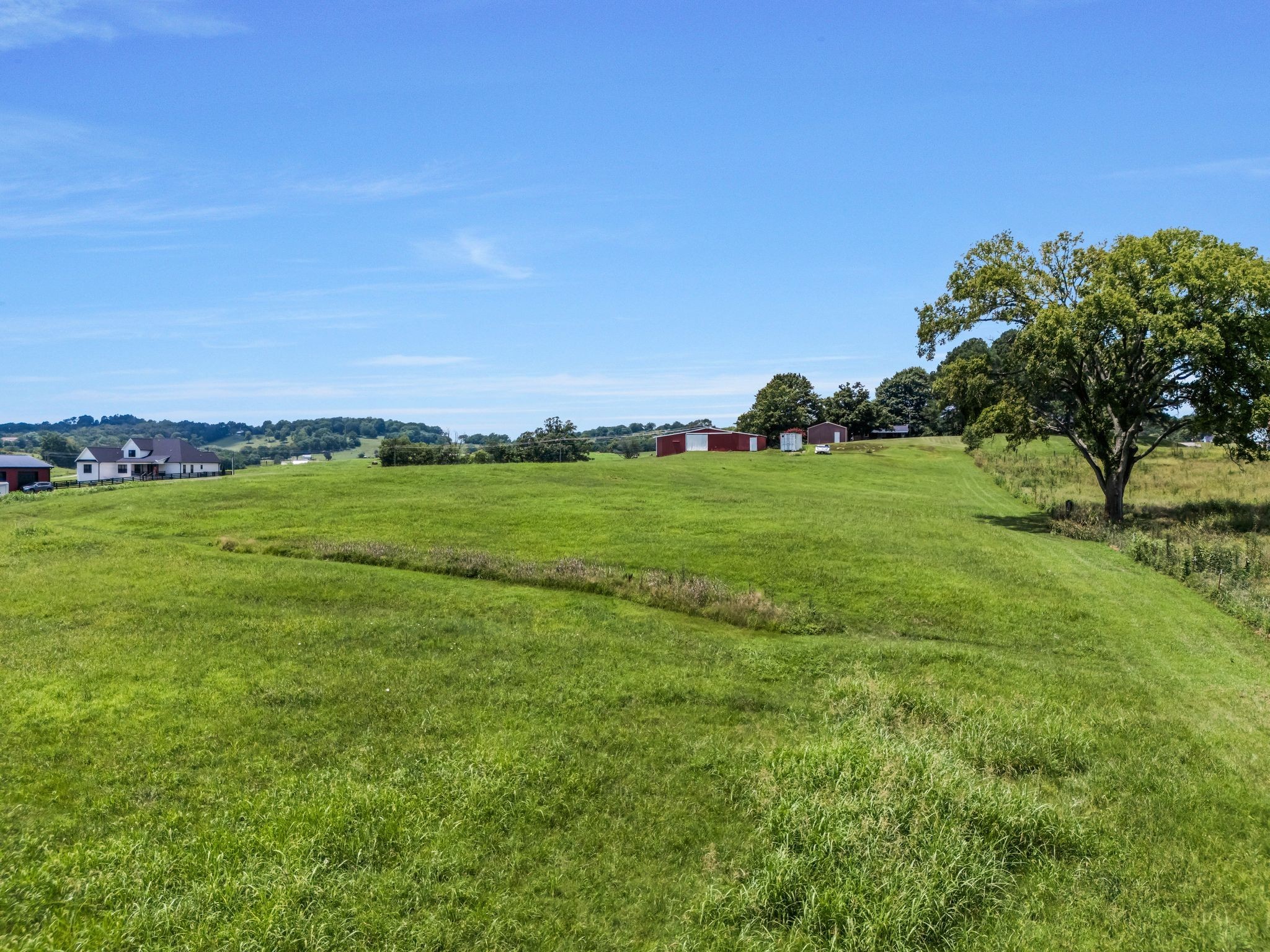 1295 Sugar Flat Road Lebanon, TN 37087 - Photo 14 of 30 a view of a field with an ocean and trees in the background