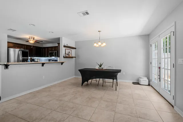 a living room with furniture a window and a chandelier