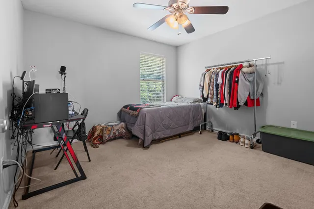 a bedroom with a bed and a chandelier