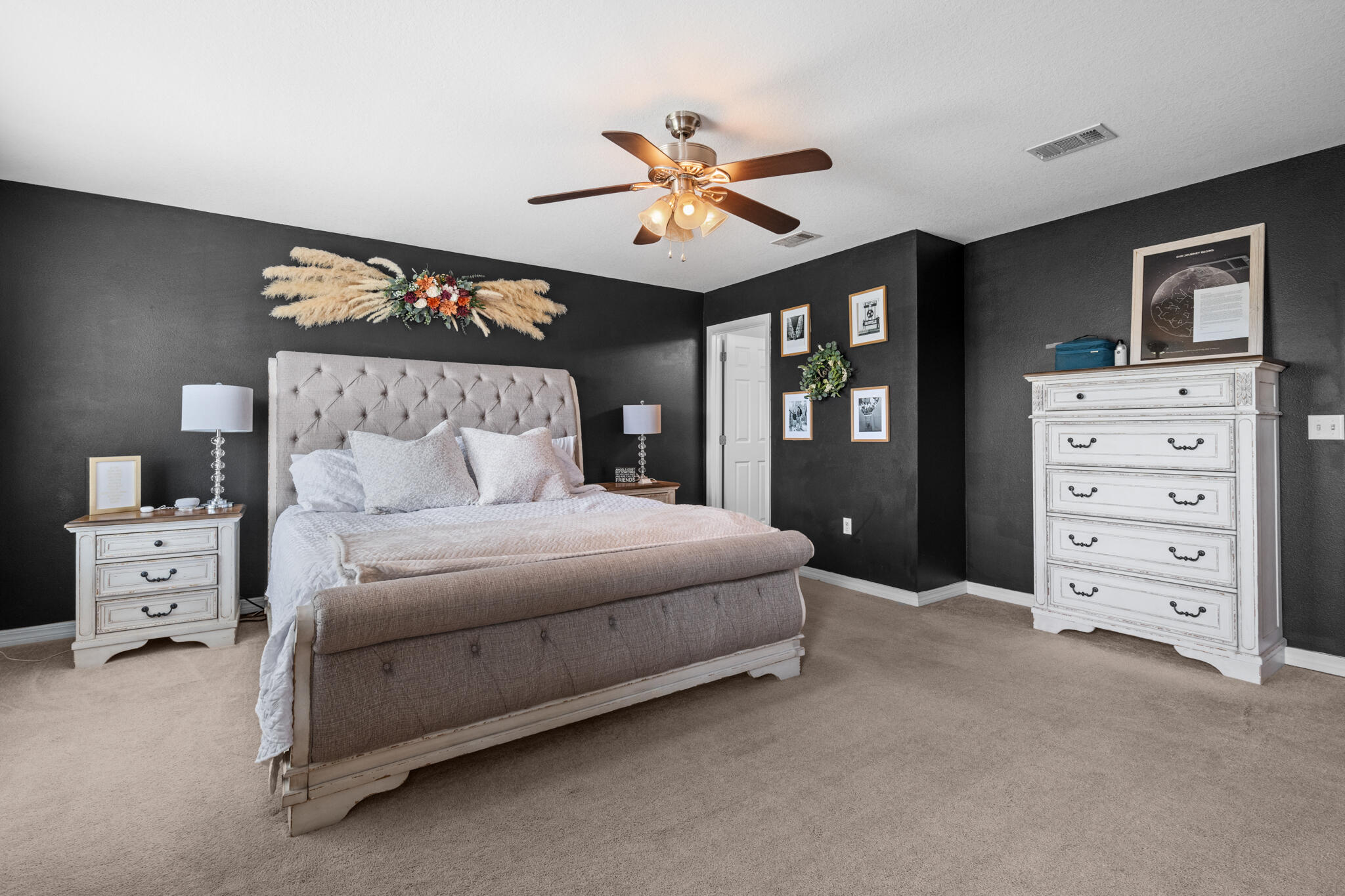 104 Lear Court Crestview, FL 32539 - Photo 20 of 27 a bedroom with a bed and a chandelier