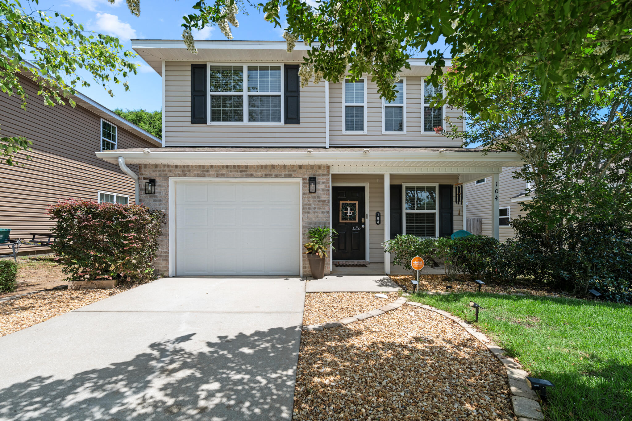 104 Lear Court Crestview, FL 32539 - Photo 2 of 27 a front view of a house with a garden and yard