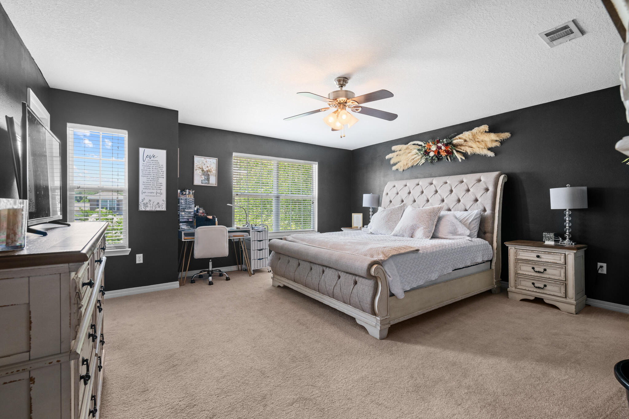 104 Lear Court Crestview, FL 32539 - Photo 21 of 27 a bedroom with a large bed and a chandelier fan