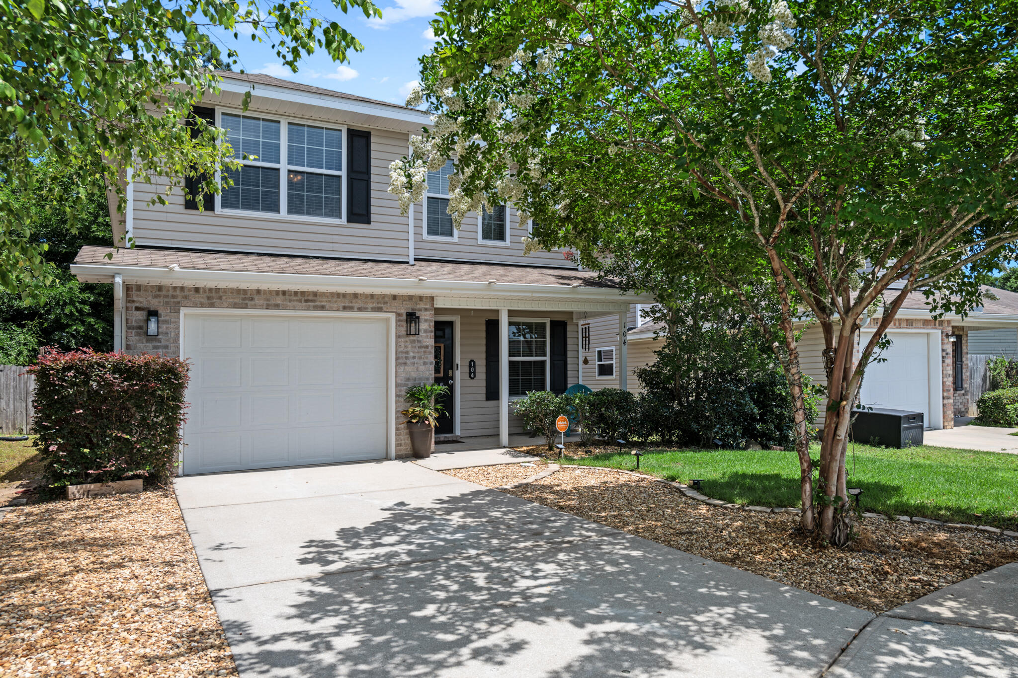 104 Lear Court Crestview, FL 32539 - Photo 3 of 27 a front view of a house with a yard and potted plants