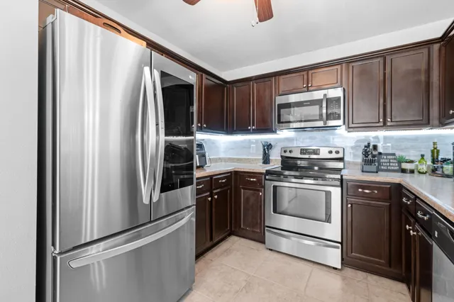a kitchen with stainless steel appliances a sink and a refrigerator