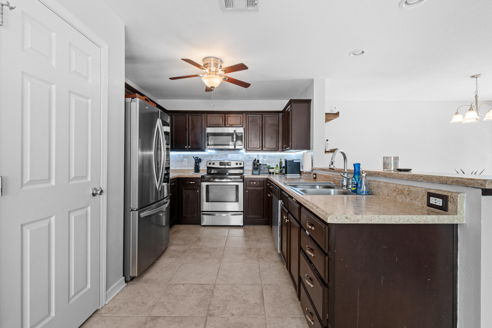 104 Lear Court Crestview, FL 32539 - Photo 9 of 27 a kitchen with stainless steel appliances a sink and a refrigerator