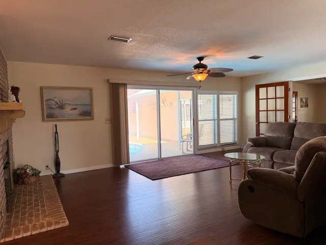 a spacious bedroom with a bed and a chandelier
