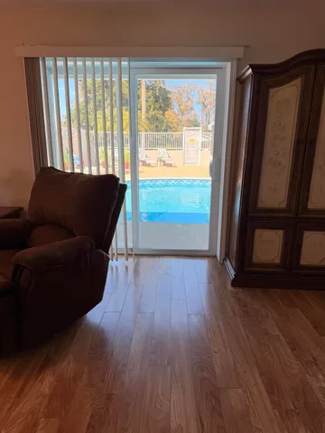 a view of a house with swimming pool and porch with furniture