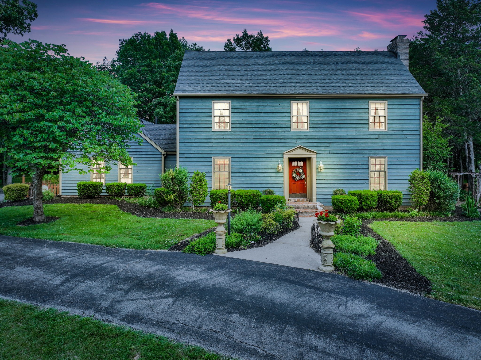a front view of a house with garden