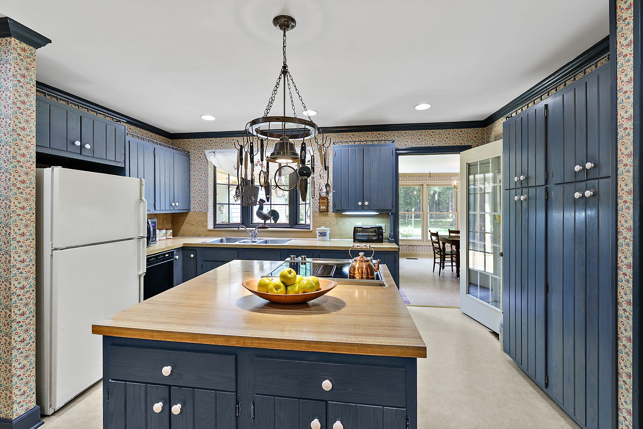 7797 Murfreesboro Road Lebanon, TN 37090 - Photo 24 of 57 a kitchen with a refrigerator a stove a dining table and chairs with wooden floor