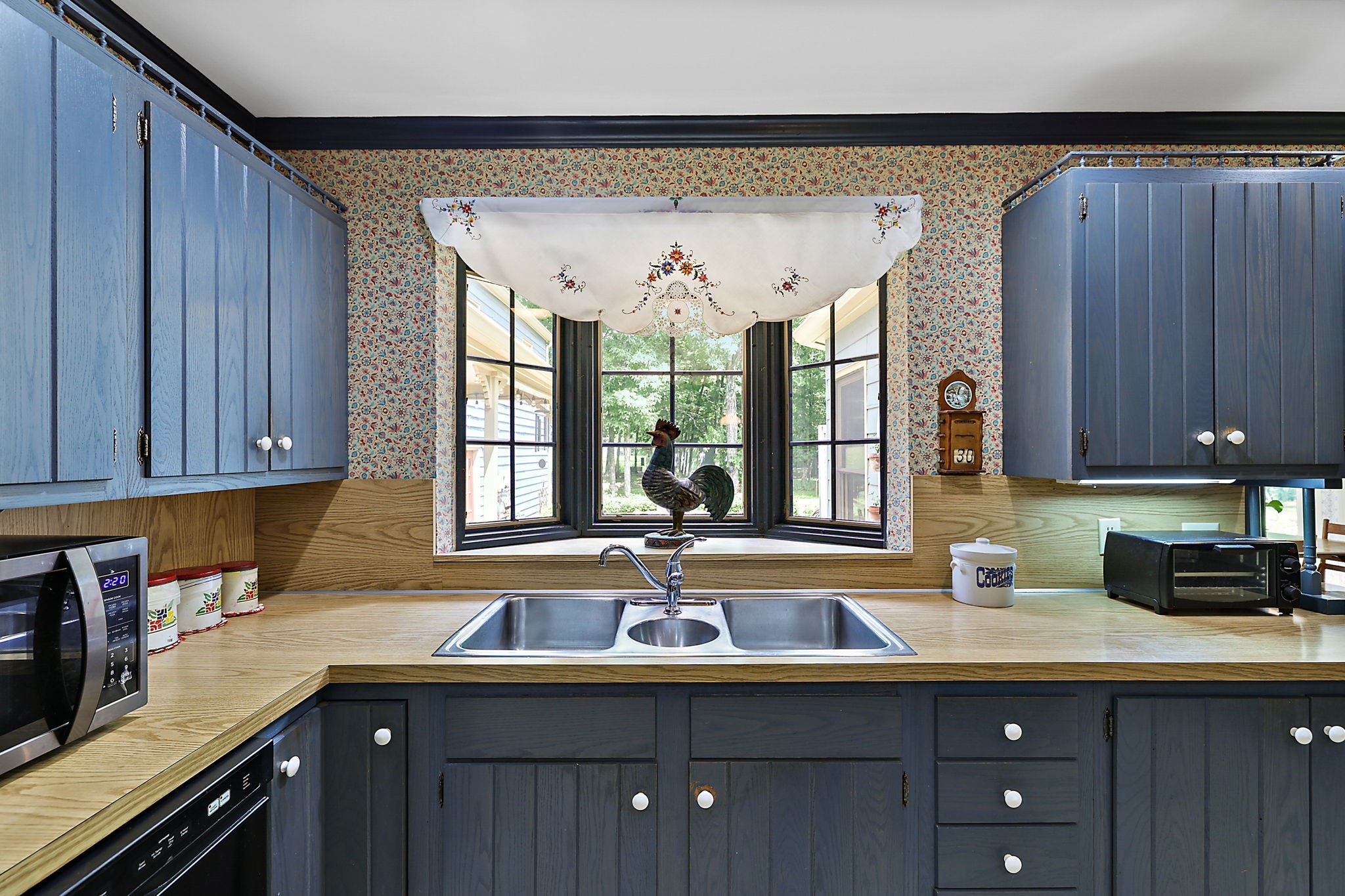 7797 Murfreesboro Road Lebanon, TN 37090 - Photo 27 of 57 a kitchen with stainless steel appliances granite countertop a sink and wooden cabinets