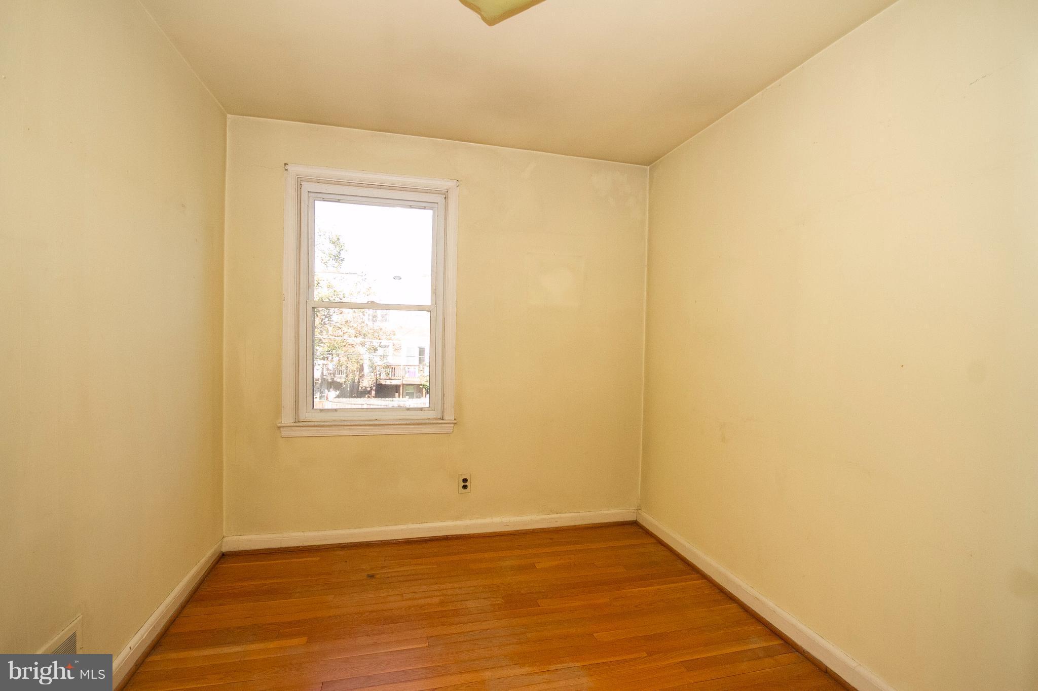 136 Garden Ridge Road Baltimore, MD 21228 - Photo 15 of 25 a view of an empty room with wooden floor and a window