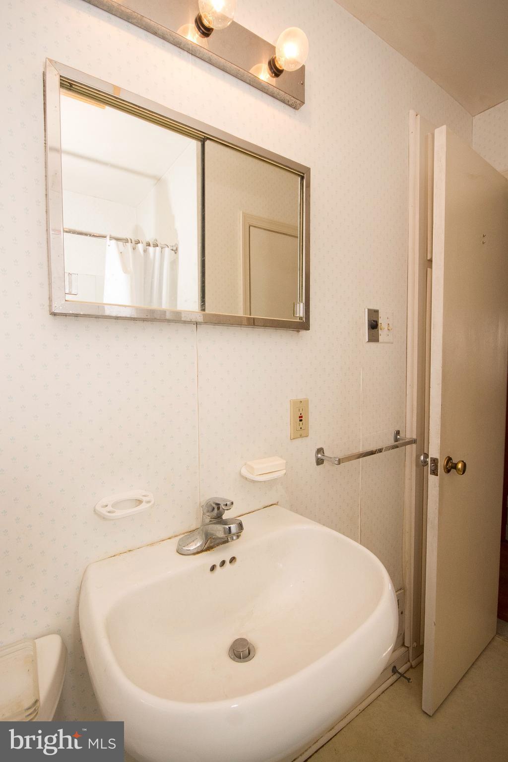 136 Garden Ridge Road Baltimore, MD 21228 - Photo 18 of 25 a bathroom with a sink and a window