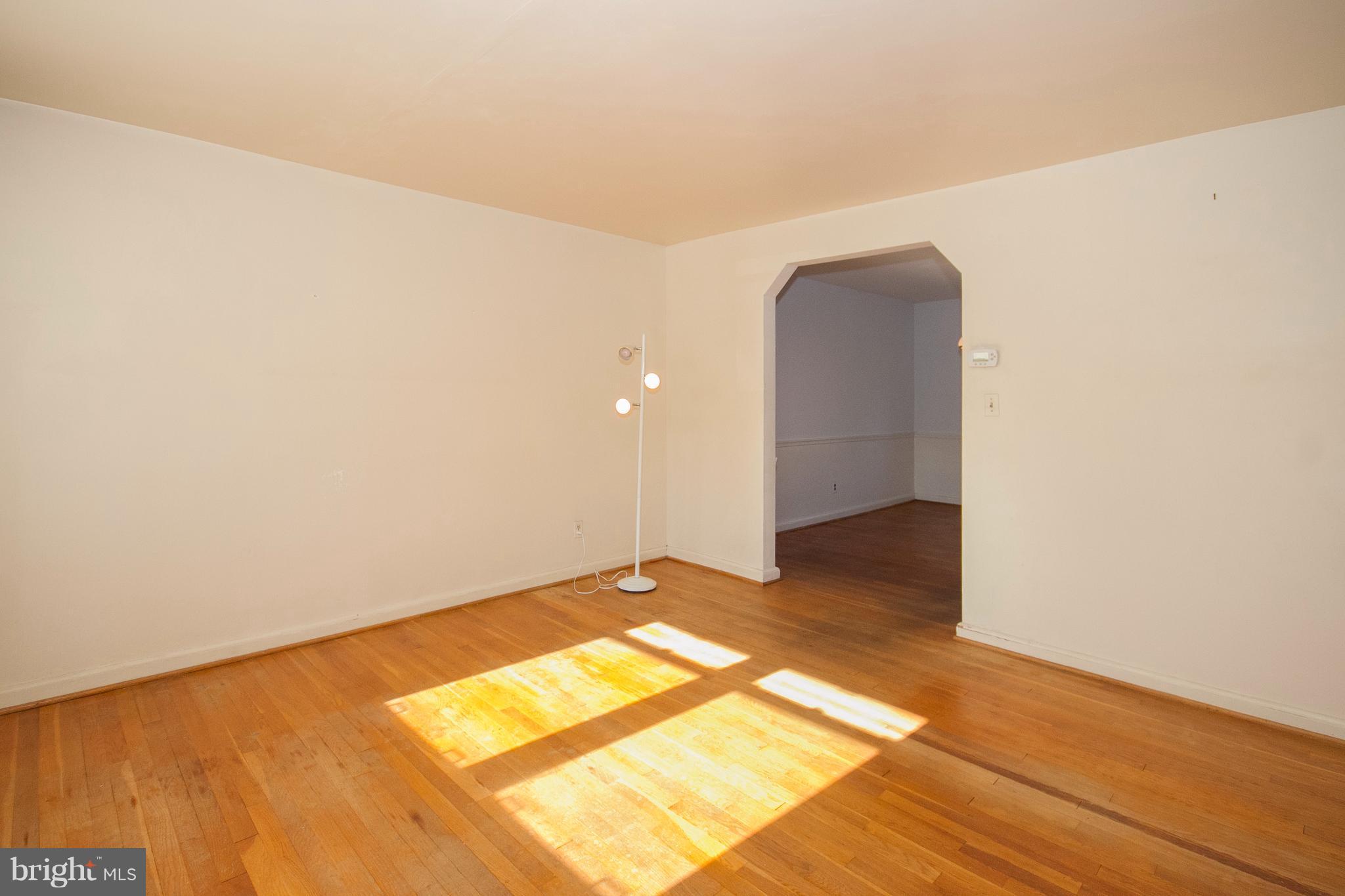 136 Garden Ridge Road Baltimore, MD 21228 - Photo 5 of 25 a view of a room with wooden floor and a white wall