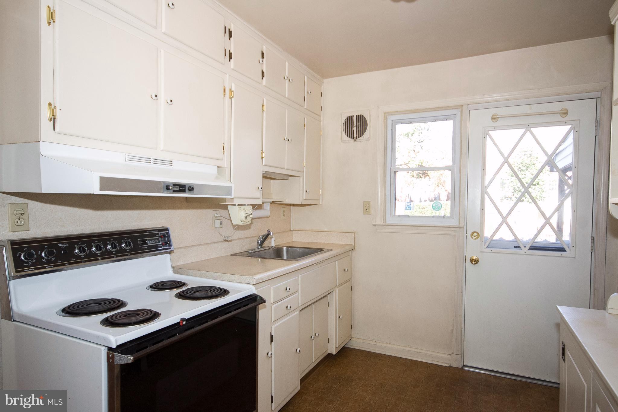136 Garden Ridge Road Baltimore, MD 21228 - Photo 8 of 25 a kitchen with appliances cabinets and a stove top oven
