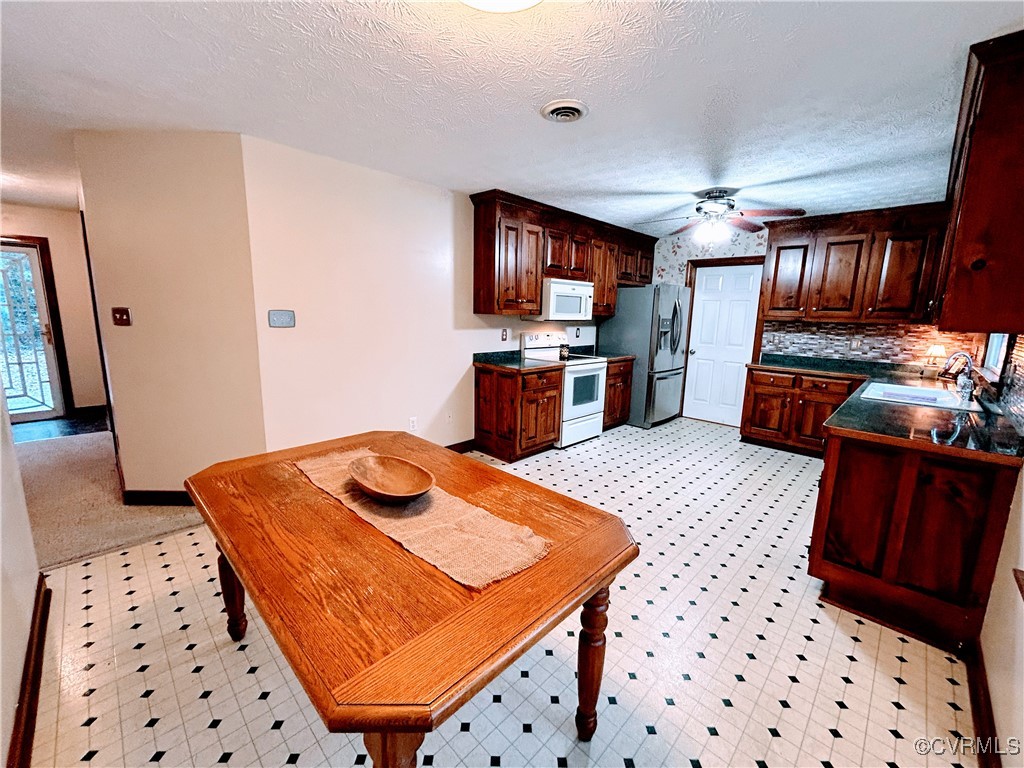 744 Millwood Road Aylett, VA 23009 - Photo 1 of 1 Kitchen featuring ceiling fan, sink, backsplash, a