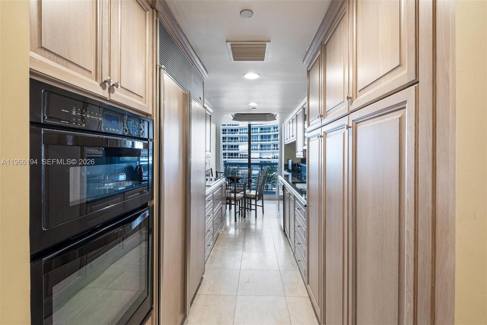 9595 Collins Avenue, Unit N6J Surfside, FL 33154 - Photo 11 of 37 a hallway with wooden floor electronic appliances and window
