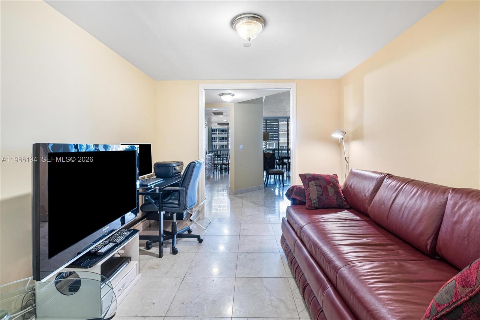 9595 Collins Avenue, Unit N6J Surfside, FL 33154 - Photo 18 of 37 a living room with furniture and a flat screen tv