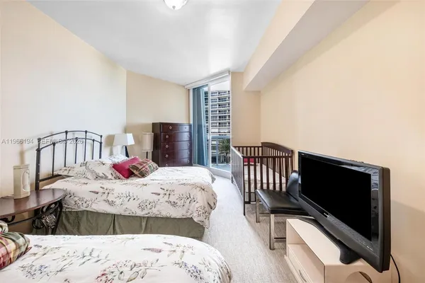 a bedroom with double bed and a window with balcony view