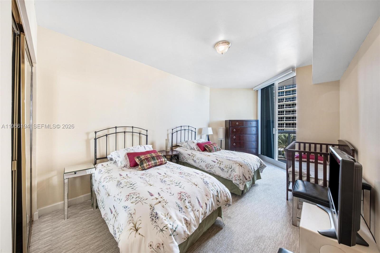 9595 Collins Avenue, Unit N6J Surfside, FL 33154 - Photo 20 of 37 a bedroom with double bed and a window with balcony view