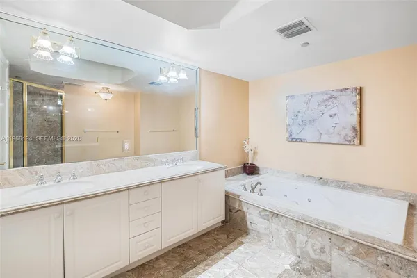 a bathroom with a granite countertop sink a toilet a mirror and shower