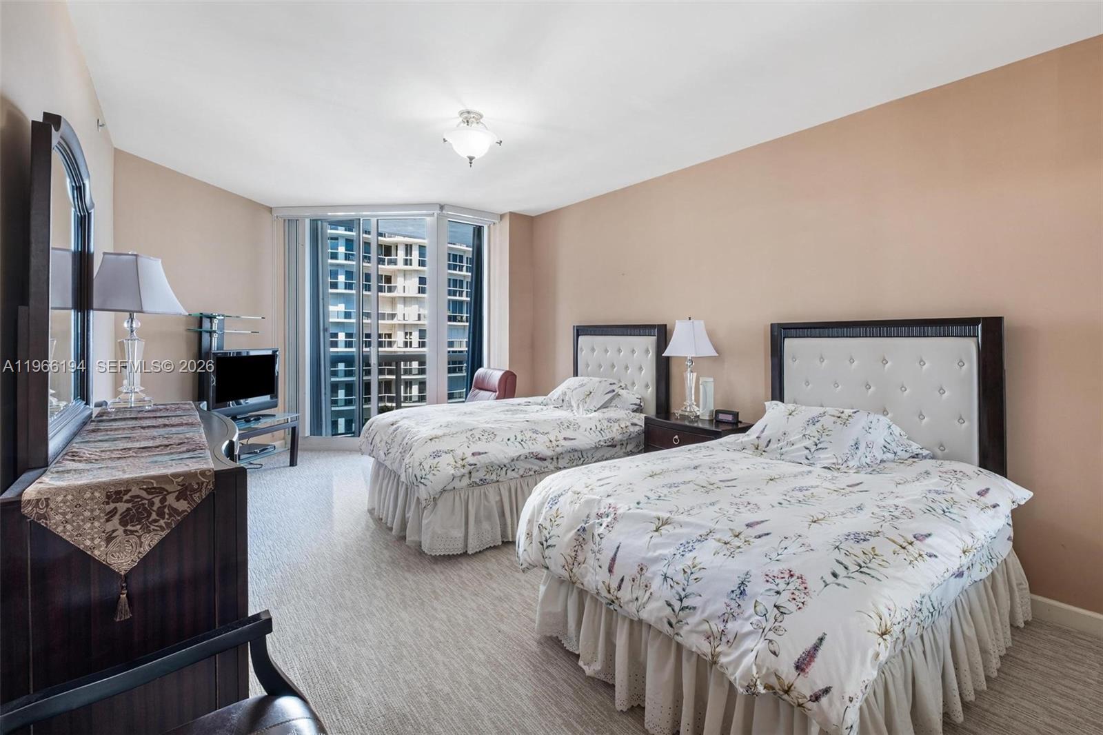 9595 Collins Avenue, Unit N6J Surfside, FL 33154 - Photo 27 of 37 a bedroom with two beds and a couch