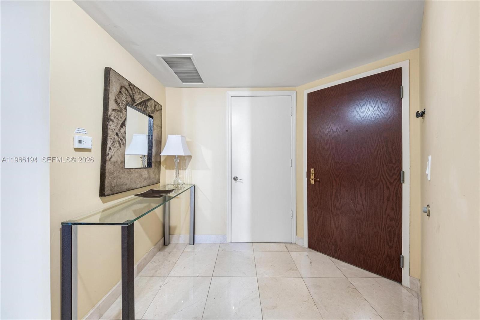 9595 Collins Avenue, Unit N6J Surfside, FL 33154 - Photo 3 of 37 a view of a kitchen from the hallway