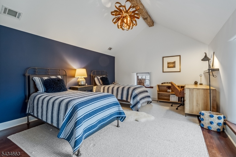 55 State Park Road Chester, NJ 07930 - Photo 19 of 48 a bedroom with two beds and a chandelier