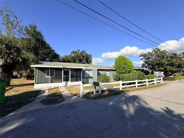 a view of a house with backyard and a patio